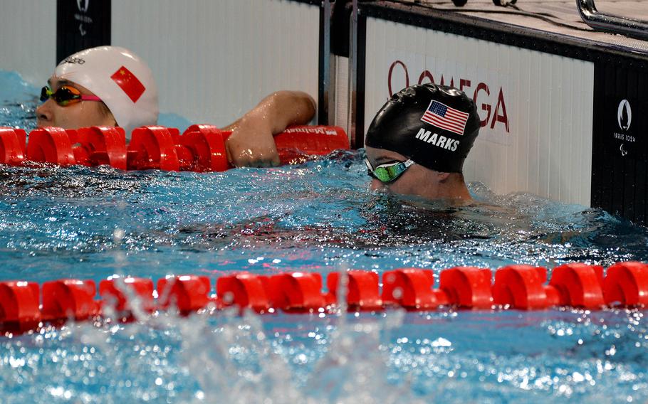 Elizabeth Marks takes a breather after swimming to silver in the women’s 100-meter backstroke event at the 2024 Paris Paralympics, Sept. 7, 2024. At left is the winner Jiang Yuyan of China who set a new world record in the race. Marks, a U.S. Army sergeant first class, won five silver medals at the Games.