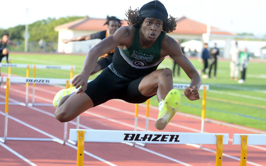 Kubasaki's Carlos Cadet navigates the 110-meter hurdles during Saturday's second day of a two-day Okinawa track and field meet. Cadet won the 110 and 300 hurdles, the long jump and the triple jump.
