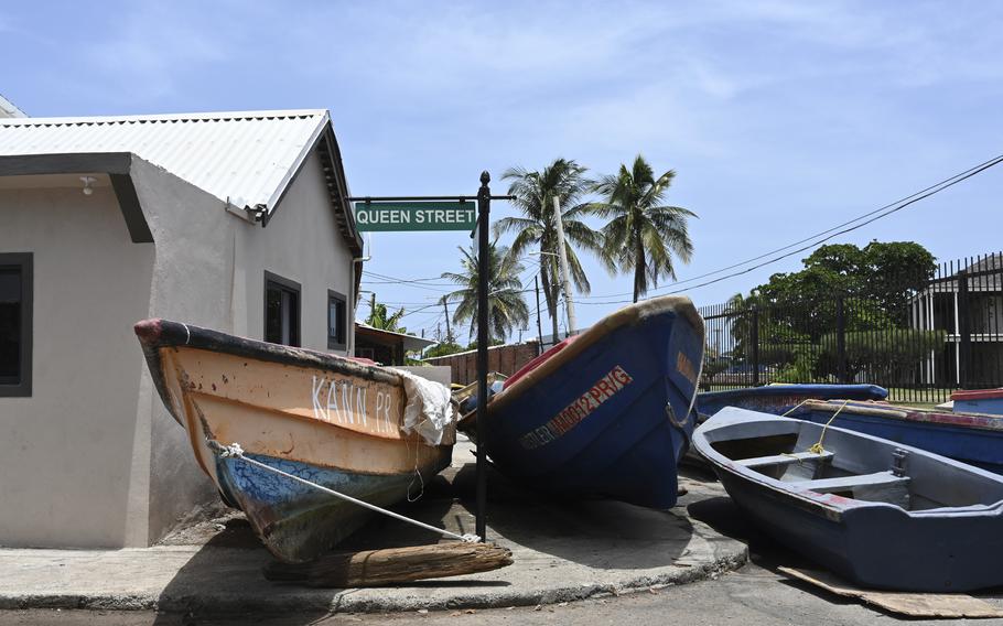Fishing boats lie in the middle of the street for protection from Hurricane Beryl in Kingston, Jamaica, Tuesday, July 2, 2024. 