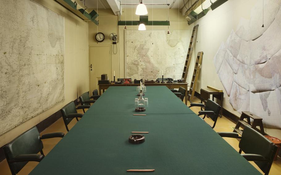 A long green table in an underground room.