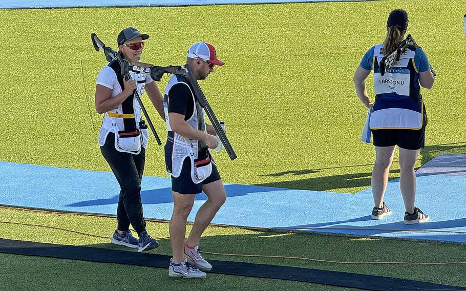 United States skeet mixed team pair Austen Smith, left, and Army veteran Vincent Hancock walk to the next position during the first round of qualification on Monday, Aug. 5, 2024, at the Chateauroux Shooting Centre in Chateauroux, France.