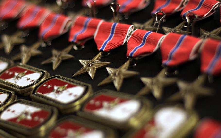 Bronze Star Medals with red ribbons are displayed.