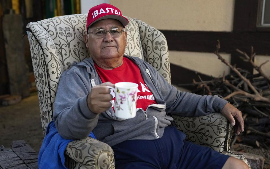 Ron Flores, a Republican, sits on his porch, Thursday, Nov. 3, 2022, in Huntington Beach, Calif. Flores is retired and helps campaign for conservative candidates. 