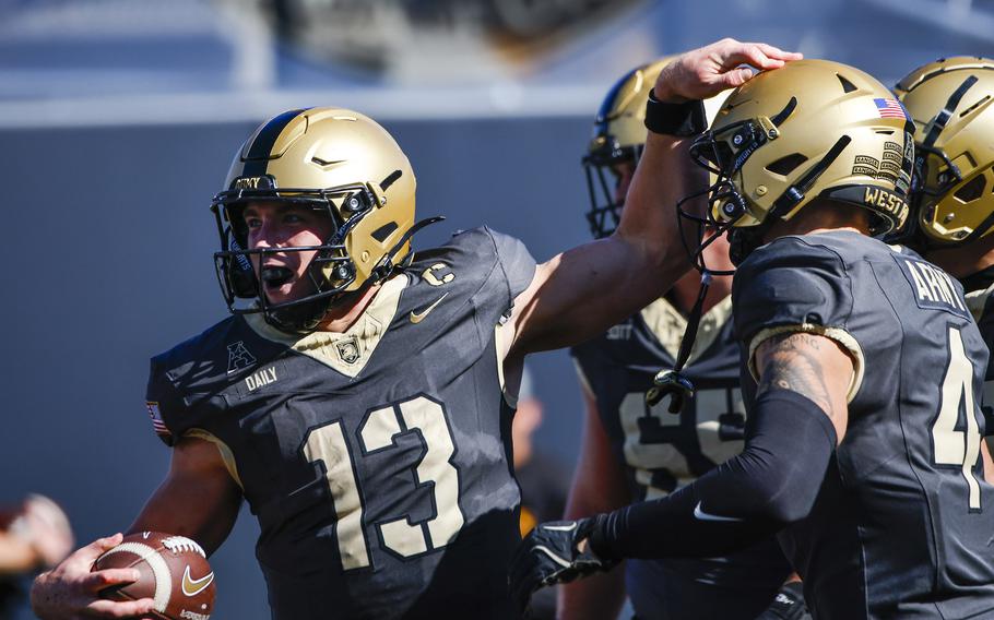 Army quarterback Bryson Daily, left, celebrates a touchdown during an NCAA college football game against East Carolina, Oct. 19, 2024, in West Point, N.Y. 