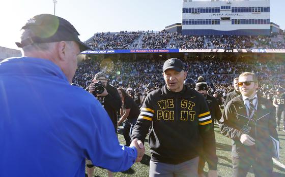 Air Force head coach Troy Calhoun, left, and Army head coach Jeff Monken, shake hands.