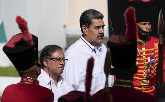 FILE - Venezuelan President Nicolas Maduro, right, stands with Colombian President Gustavo Petro after Petro arrived at Miraflores presidential palace in Caracas, Venezuela, Saturday, Nov. 18, 2023. (AP Photo/Ariana Cubillos, File)