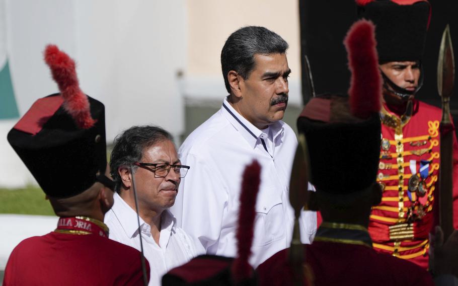 Venezuelan President Nicolas Maduro, right, stands with Colombian President Gustavo Petro after Petro arrived at Miraflores presidential palace in Caracas, Venezuela