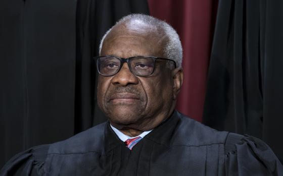 FILE - Associate Justice Clarence Thomas joins other members of the ...