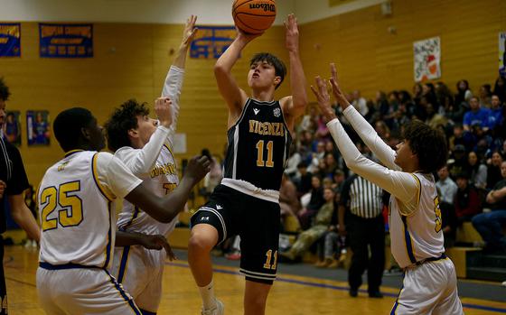 Vicenza's Ben Harlow goes up for a runner among Wiesbaden defender, from left, Joel Idowu, Jonah Harvey and Carter Edwards during a Jan. 10, 2025, game at Wiesbaden High School in Wiesbaden, Germany.