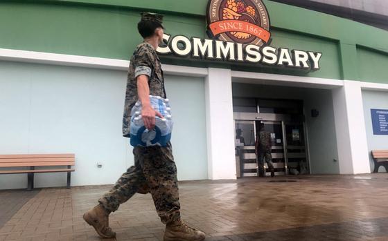 Lance Cpl. Gage Baird, 23, walks out of the commissary with groceries at Marine Corps Air Station Iwakuni, Japan, Thursday, Aug. 29, 2024. 