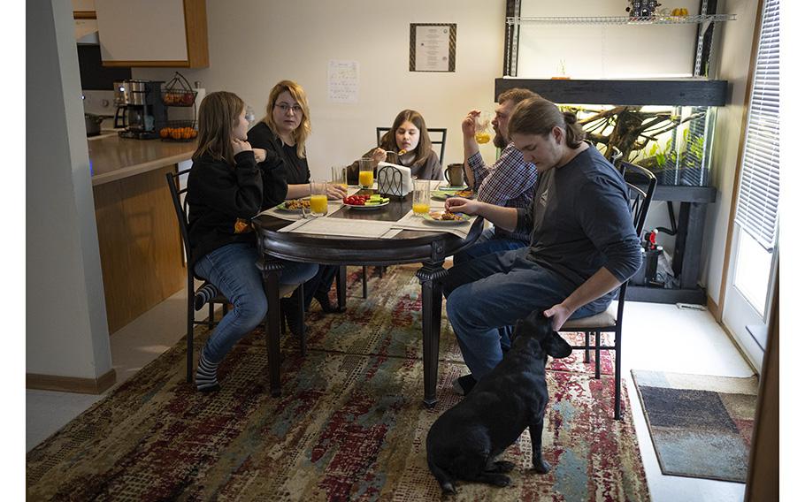 Sitting down for dinner in their Shakopee, Minn., home are, from left, Dasha, Kayta, Polina, Artem, and Kirill, on March 15, 2023. 