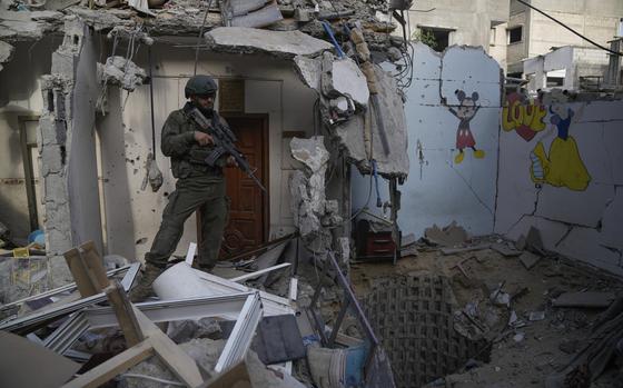 An Israeli soldier stands at the entrance of a tunnel where the military says six Israeli hostages were recently killed by Hamas militants in the southern Gaza Strip on Friday, Sept. 13, 2024. (AP Photo/Leo Correa)