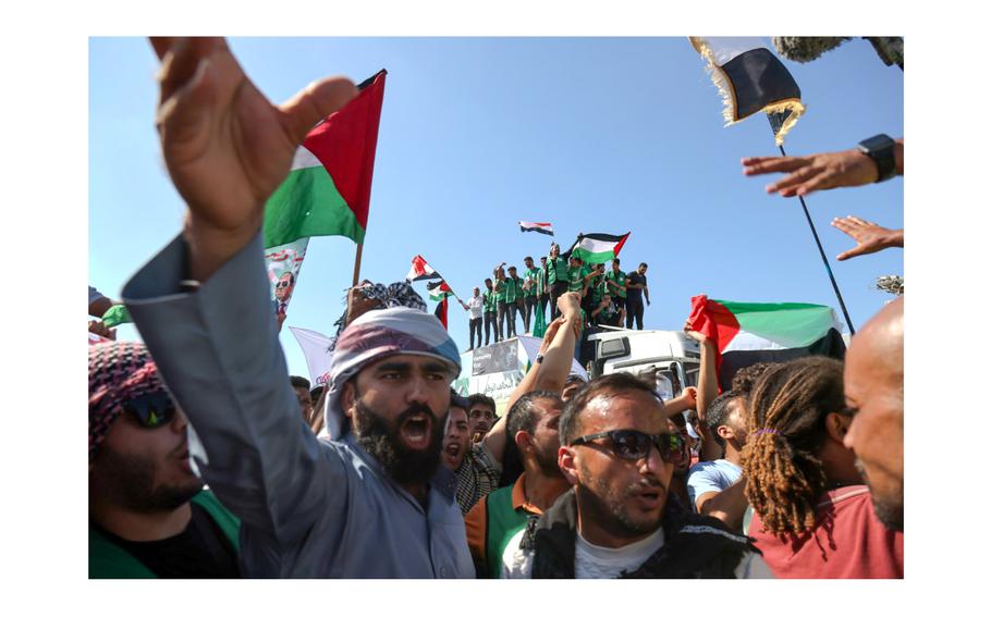 Demonstrators gather while United Nations Secretary General António Guterres visits the Rafah border crossing between Egypt and the Gaza Strip on Friday, Oct. 20, 2023.