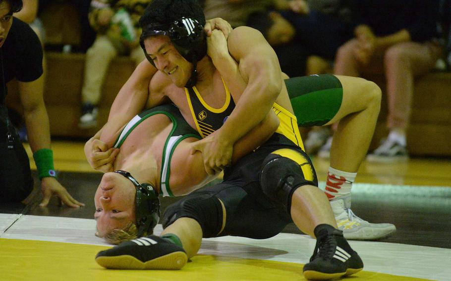 Kadena's Joseph Oh takes control of Kubasaki's Brady Potter at 145 pounds during Wednesday's Okinawa wrestling dual meet. Oh won by pinl and the Panthers won the meet.