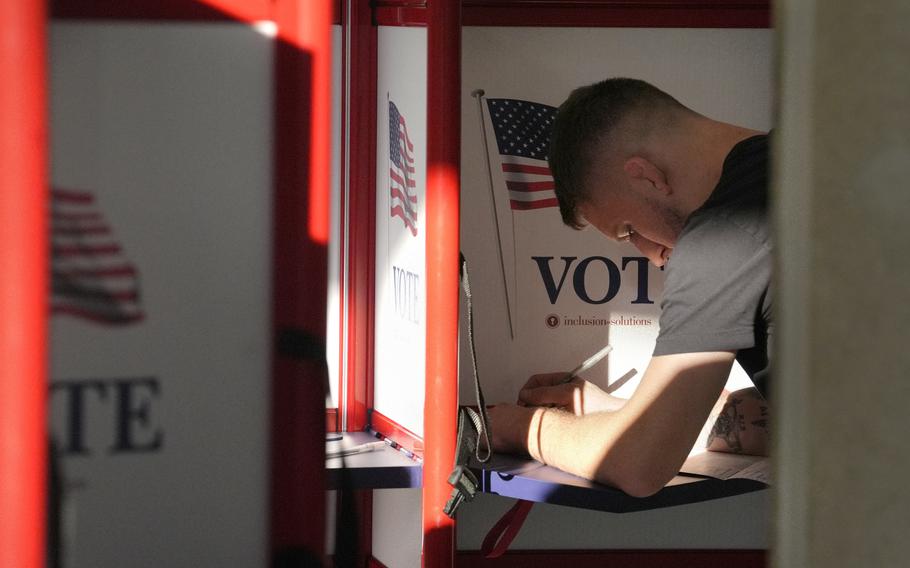 A voter fills out a ballot.