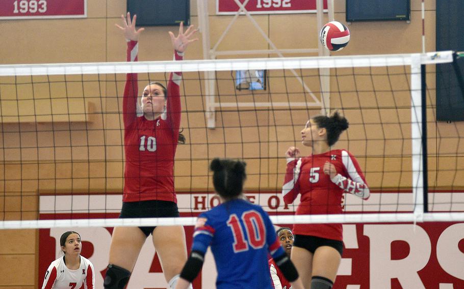 Raider players Mariska Campbell, left, and Libbie Bergeron try to block an attack by Ramstein's M.J. Davis during a match on Oct. 6, 2023, at Kaiserslautern High School in Kaiserslautern, Germany.