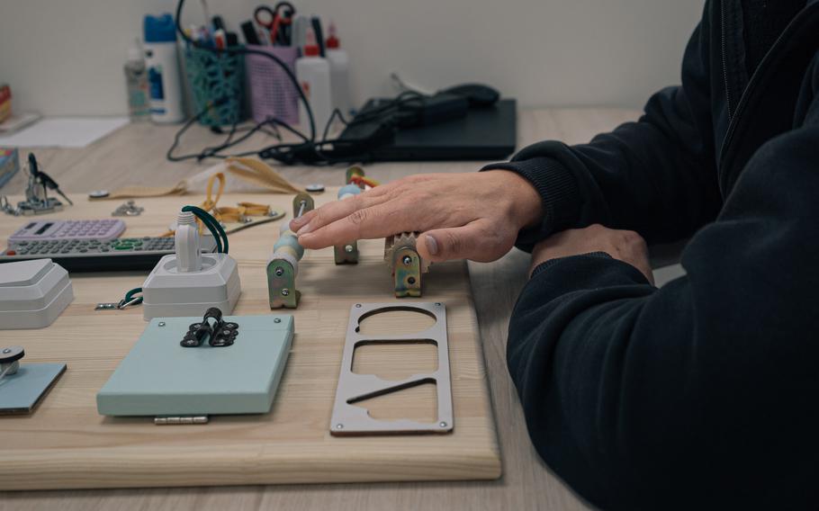 A Ukrainian service member’s hand is outstretched for therapy to improve fine motor skills.