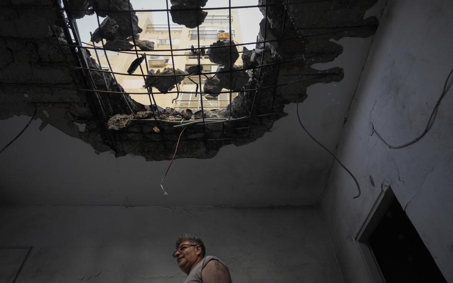 A man examine his damaged apartment in northern Israel, on Tuesday, Oct. 8, 2024.