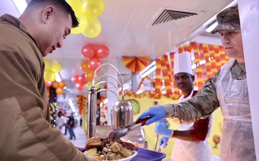 Col. Daniel Enslen serves Thanksgiving dinner at Camp Arifjan in Kuwait on Nov. 23, 2023.