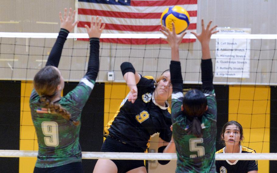 Kadena's Jenna Cook spikes against Kubasaki's Hailey Brassard and Rameghlyn Doctolero during Tuesday's Okinawa girls volleyball match. The Panthers won in straight sets.