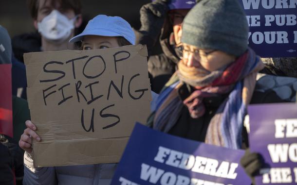 FILE - Demonstrators rally in support of federal workers outside of the Department of Health and Human Services, Feb. 14, 2025, in Washington. (AP Photo/Mark Schiefelbein, File)