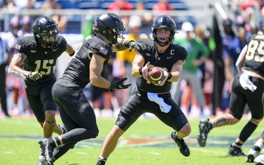 Army quarterback Bryson Daily hands off to running back Hayden Reed