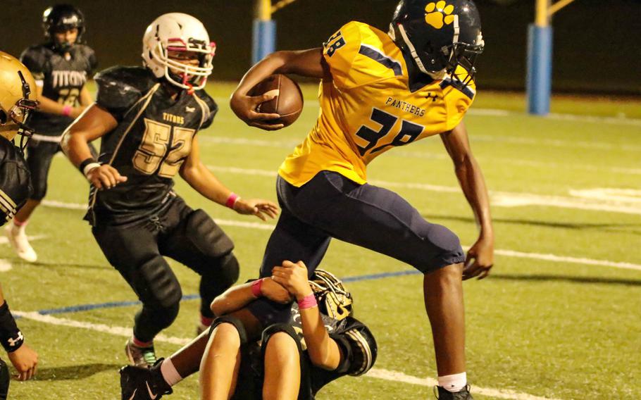 Guam High receiver Robert Ellis tries to shake a couple of Tiyan defenders.