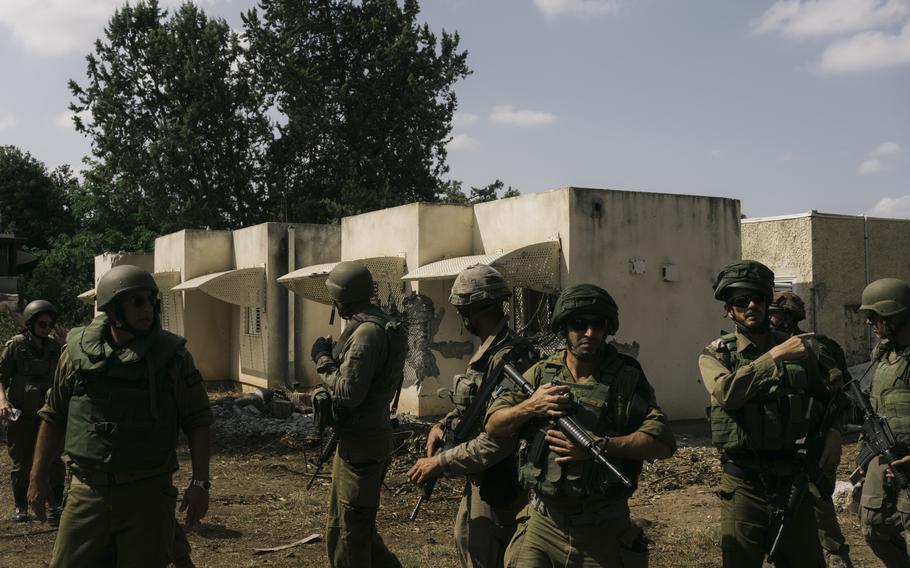 Israeli soldiers search Kfar Azza on Tuesday. Military officials said the village was finally secured late Monday after 2½ days of intense fighting.