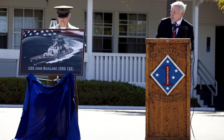 Then-Secretary of the Navy Ray Mabus , right, has a graphic of the USS John Basilone unveiled during the naming ceremony for the ship at Camp Pendleton, Calif., in 2016. Named for Gunnery Sgt. John Basilone, who was awarded the Medal of Honor in World War II, the ship was delivered to the Navy on July 8, 2024.