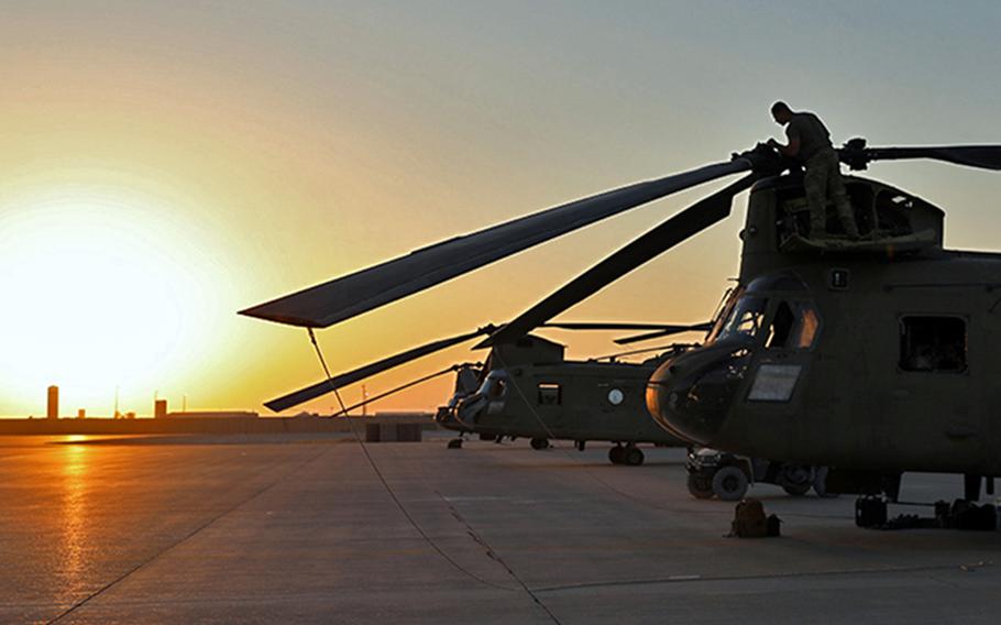 U.S. soldiers load cargo onto CH-47 Chinooks at al Asad Air Base in Iraq in August 2023.