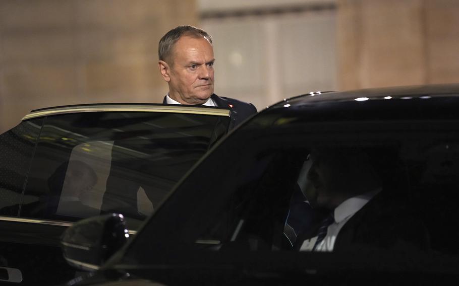 Donald Tusk gets into his car as he leaves the Elysee Palace.