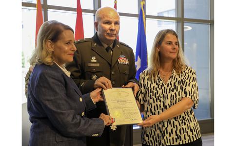 Major General Ray Shields, the adjutant general of New York, presents the New York State Conspicuous Service Cross, to the niece and grand-niece of Pvt. John Greschiak, a World War II Soldier who was killed in action on Sept. 16, 1944, during a ceremony at which he was posthumously at New York National Guard headquarters in Latham, New York on Sept. 16, 2024. They, at left, Donna Cramer of Albany, and Cheri Gagliardi, a Rotterdam resident. (U.S. Army National Guard Photo by Stephanie Butler)