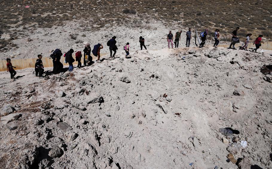 A trail of refugees crosses into Syria on foot from Lebanon, Oct. 5, 2024.