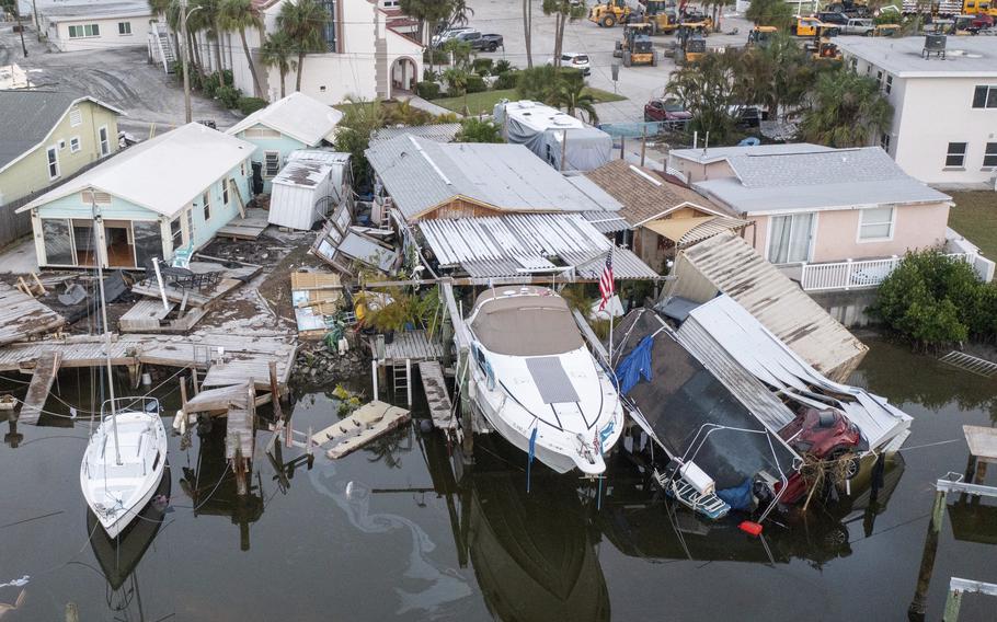 Damaged homes and a vehicle collapsed into water in Madeira Beach, Fla., on Sept. 28, 2024, after Hurricane Helene.