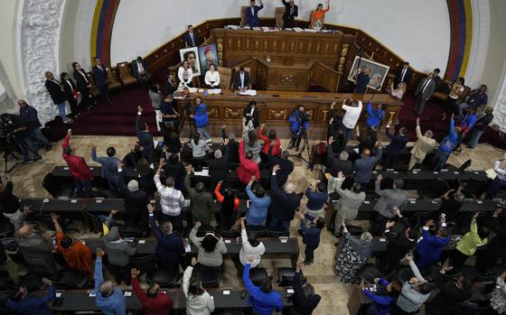 Lawmakers vote for a bill that codifies economic sanctions as a crime against humanity and allows the prosecution of anyone who expresses support for the measures, in Caracas, Venezuela, Thursday, Nov. 28, 2024. (AP Photo/Ariana Cubillos)