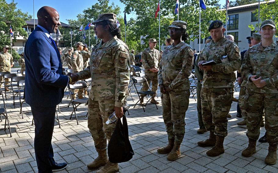 Airmen shake hands with Kaleth O. Wright