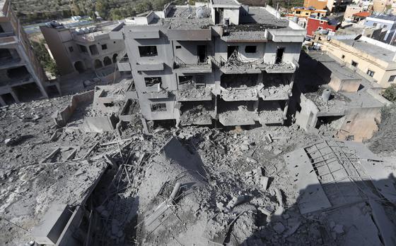 Destroyed buildings that were hit by Israeli airstrikes are seen in Qana village, south Lebanon, Wednesday, Oct. 16, 2024.