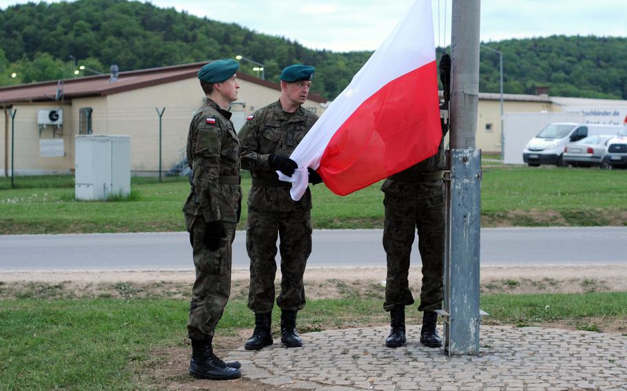 Polish forces raise their flag.