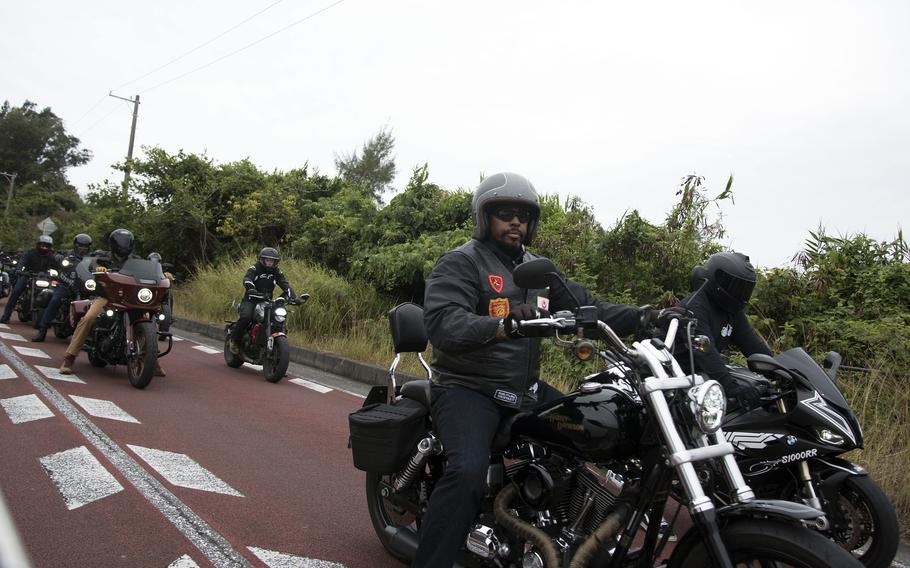 U.S. troops and members of the Okinawa American Legion cruise down Route 58 on their motorcycles.