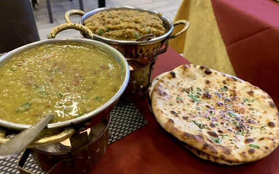 The Indian food at Mughal-e-Azam in Naples, Italy, is characteristic of the cuisine in the Punjab region, an area shared with Pakistan. Pictured are dal tarka made with split lentils, left; baingan bharta, a meal of minced roasted eggplant with onions and tomatoes; and garlic naan. 