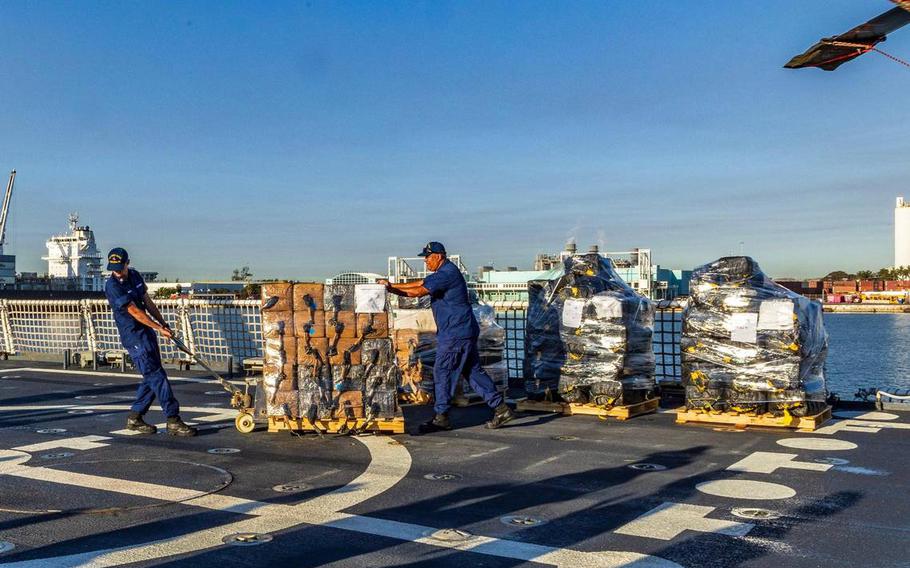 U.S Coast Guard officers offload pallets