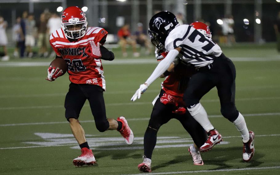 Nile C. Kinnick's KaVaughn Woodson looks for running room against Zama's Geovanni Joell.