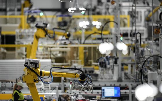 FILE - Articulated robots move inside the Hanwha Qcells Solar plant, Oct. 16, 2023, in Dalton, Ga. On Thursday, April 25, 2024, the U.S. government issues the first of three estimates of economic growth in the first quarter. (AP Photo/Mike Stewart, File)