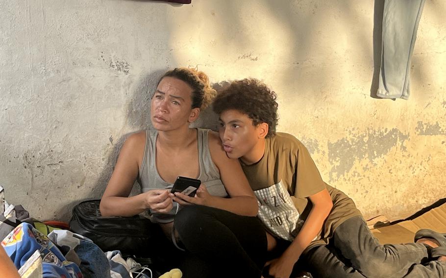 Venezuelan migrant rests with son