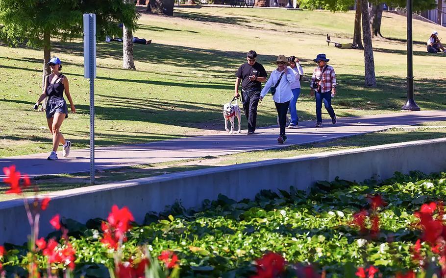 People walk around Echo Park Lake in Los Angeles on July 28, 2024. 