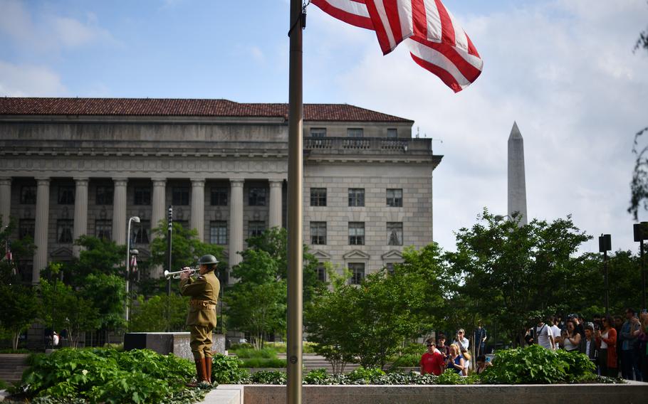 Chris Gekker, the son and grandson of immigrants who fought for America in two World Wars, plays taps on Monday, May 27, 2024. 