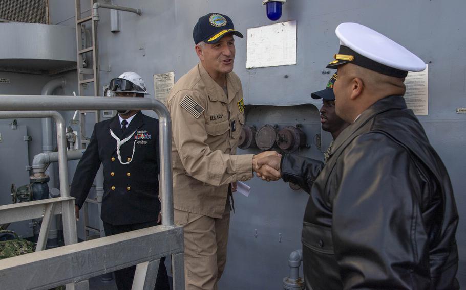 Rear Adm. Ted LeClair, deputy commander, Naval Surface Forces, U.S. Pacific Fleet, shakes hands with Cmdr. Byron Stocks.