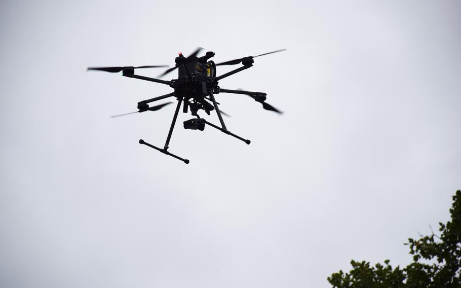 A drone flies overhead.