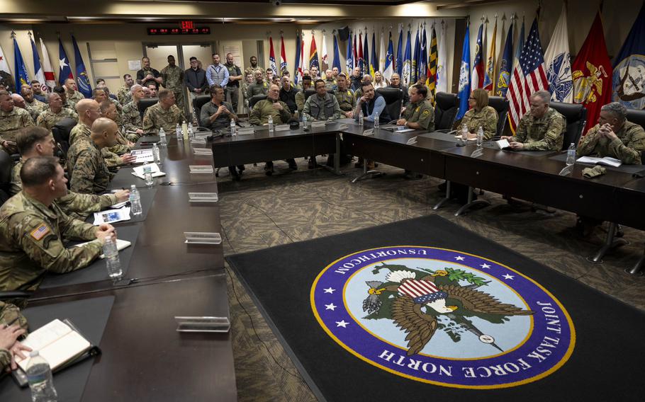 Hegseth and military leaders sitting around a table.