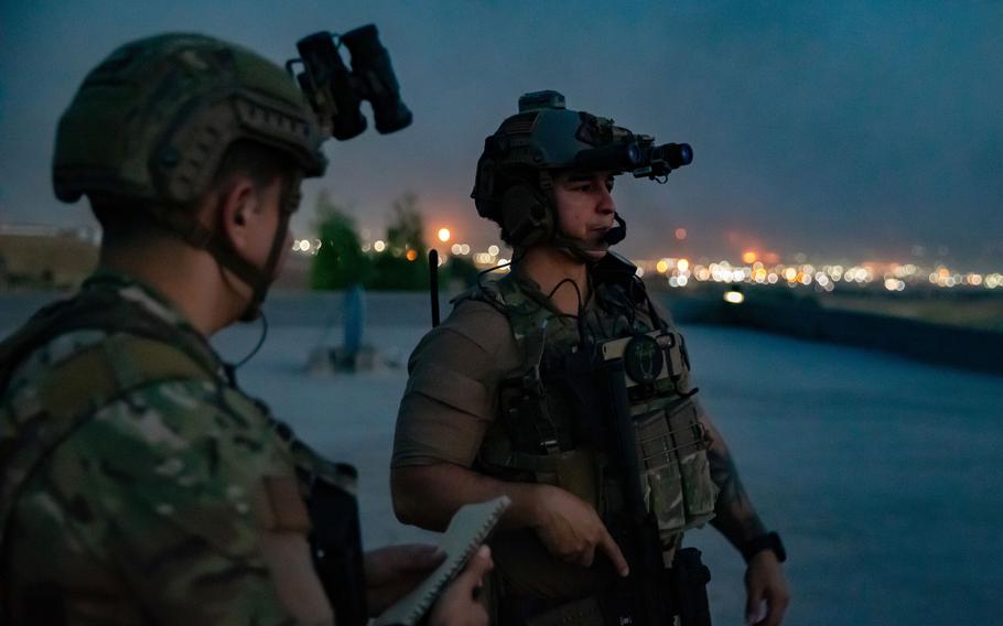 U.S. soldiers work alongside service members from the Air Force, Marine Corps and German armed forces during an aerial gunnery exercise with AH-64 Apache helicopters in northern Iraq.